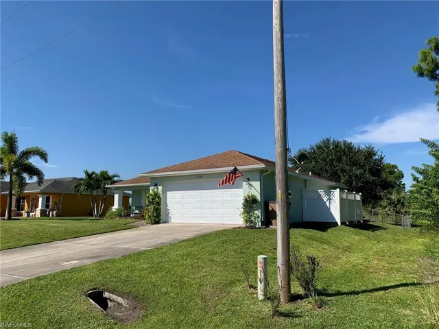 Ranch-style home with driveway, stucco siding, and a garage