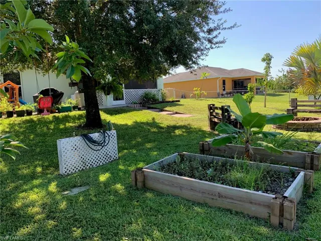 View of yard with a vegetable garden and a patio