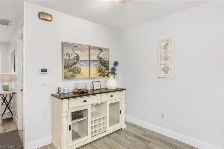 Hallway with light wood finished floors and baseboards
