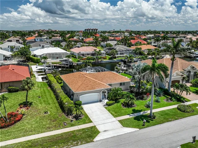 Aerial perspective of suburban area featuring a large body of water