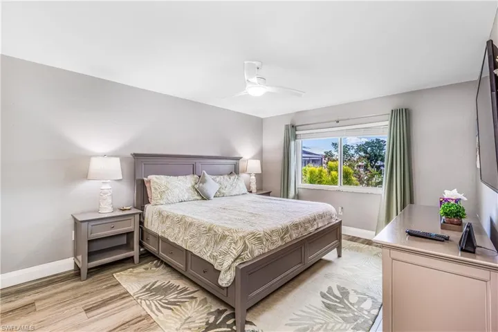 Bedroom with light wood finished floors and a ceiling fan
