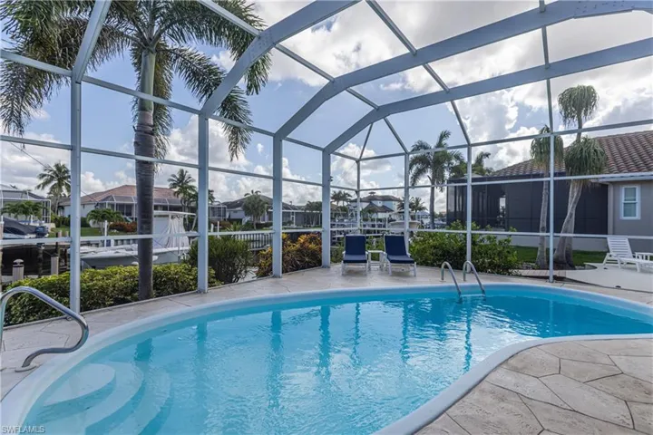 Outdoor pool featuring a patio area, a lanai, and a residential view