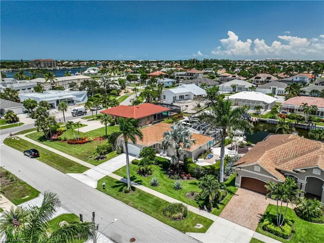 Aerial perspective of suburban area featuring a nearby body of water
