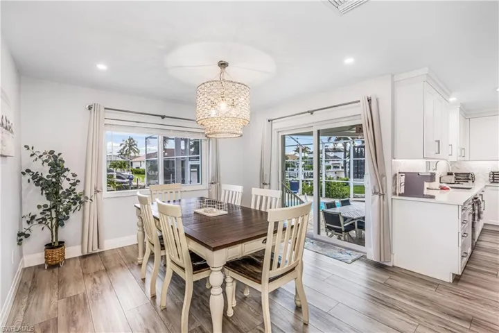 Dining room with recessed lighting, a chandelier, and light wood finished floors