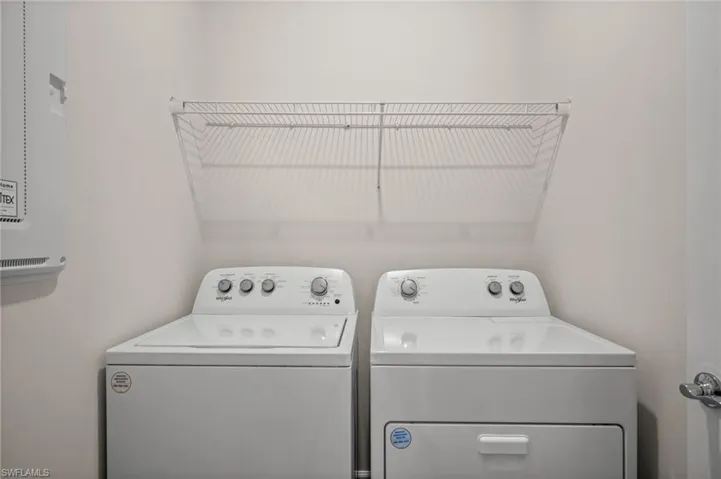 Laundry room with washing machine and clothes dryer