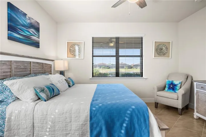 Bedroom with tile patterned floors and a ceiling fan