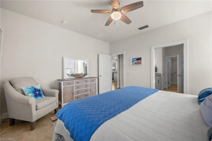 Bedroom featuring tile patterned flooring and ceiling fan