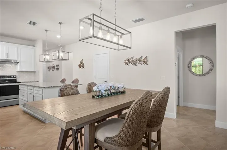 Dining area with recessed lighting and light tile patterned flooring