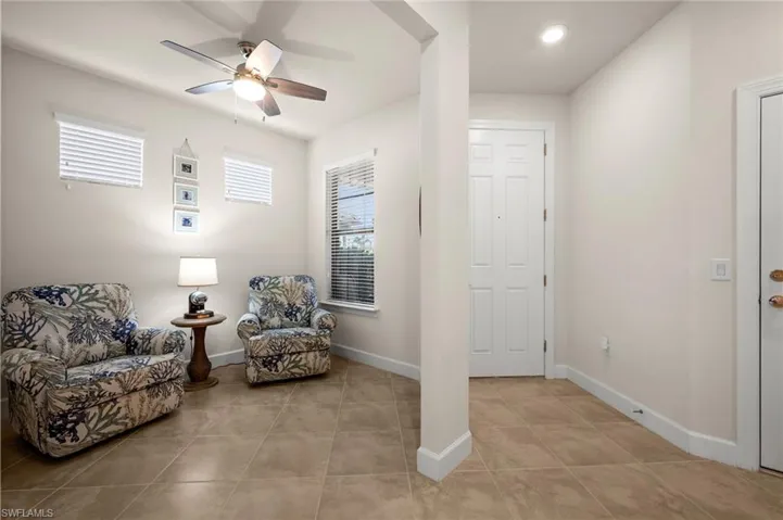 Sitting room featuring baseboards and ceiling fan