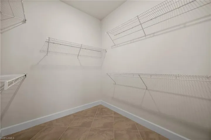Walk in closet featuring light tile patterned flooring