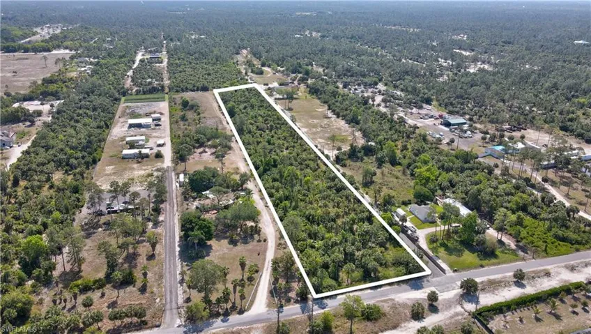 Drone / aerial view with a wooded view