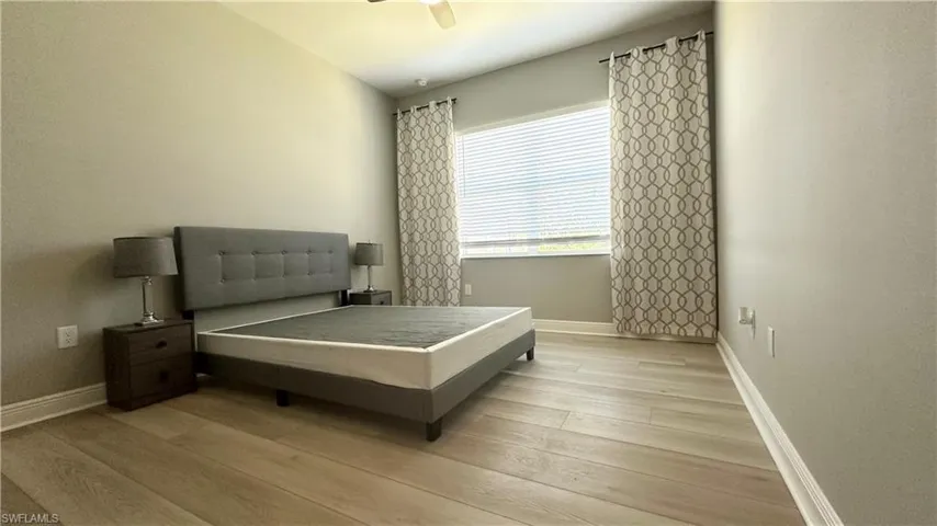 Bedroom featuring light wood-type flooring and a ceiling fan
