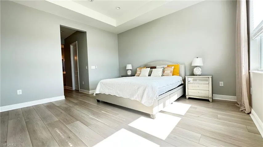 Bedroom with light wood finished floors and baseboards