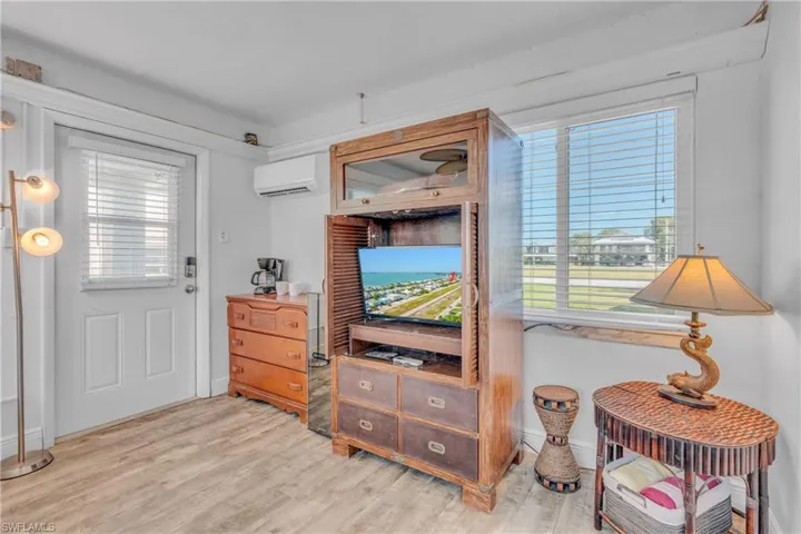 Sitting room featuring light wood-style floors and a wall mounted mini split