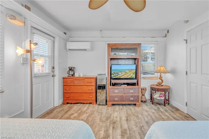 Bedroom with ceiling fan and light wood-style floors