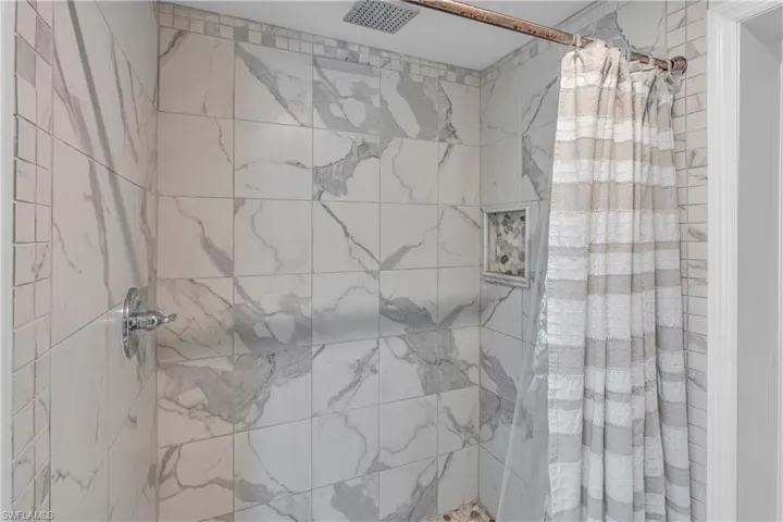 Full bath featuring a shower stall