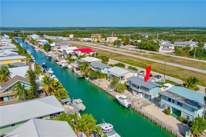 Aerial view of residential area featuring a nearby body of water