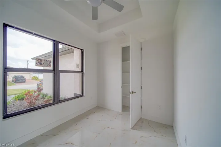 Spare room featuring ceiling fan and a raised ceiling
