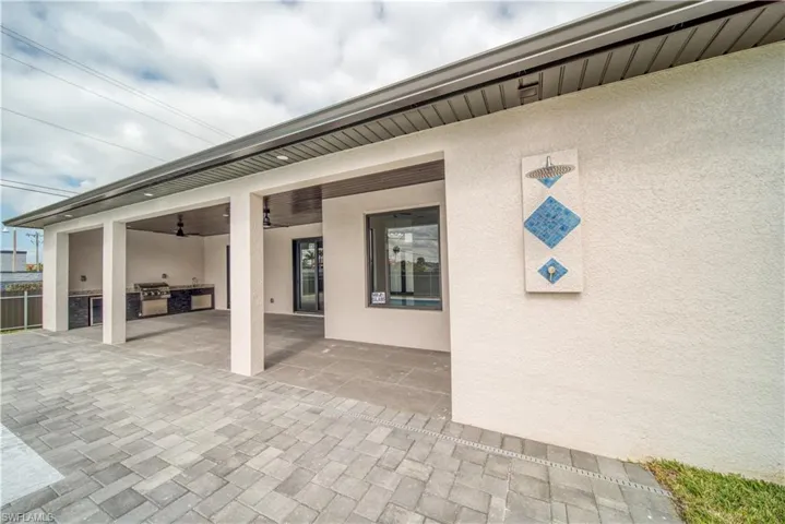 View of patio with ceiling fan, grilling area, and exterior kitchen