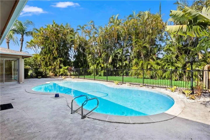View of fenced swimming pool with a patio and lots of privacy!