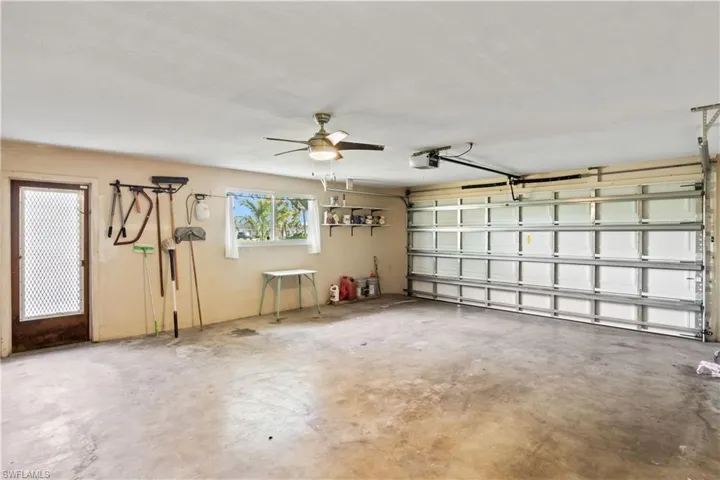 Garage with a garage door opener and ceiling fan