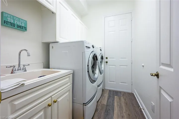 Laundry Room with Tub Sink, Front Load Washer and Dryer with access to the Car Garage