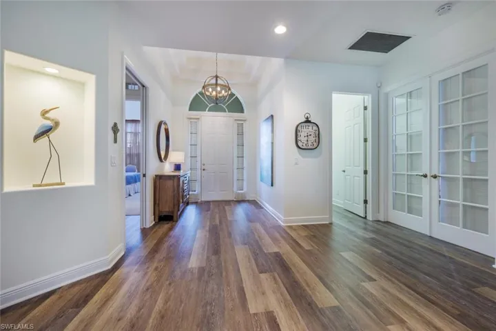 Entryway featuring  tray ceiling, and an inviting chandelier