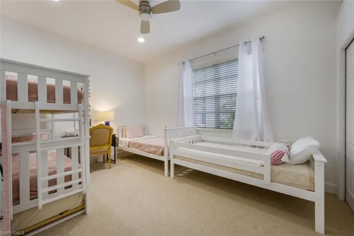 Carpeted guest bedroom with space to sleep 5 including a trundle bed