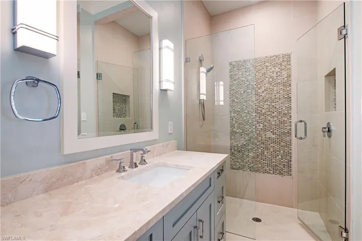 Bathroom with a shower stall and vanity