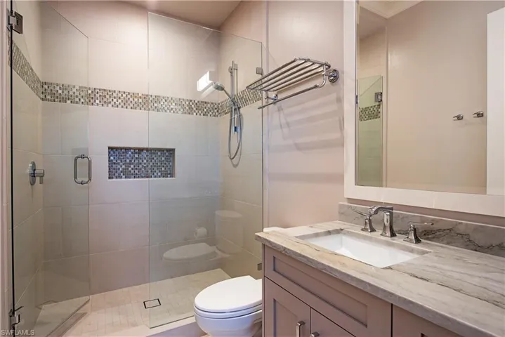 Bathroom featuring vanity and a stall shower