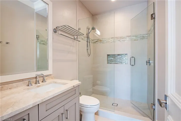 Bathroom featuring vanity and a stall shower