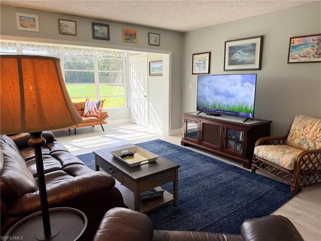 Living area featuring expansive multi-pane windows and light-toned wood-finish flooring