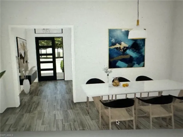Spare room featuring a raised ceiling, ceiling fan, and light marble finish floors
