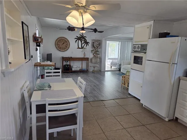 Light & bright Kitchen features solid-surface counters, tile backsplash & all appliances.