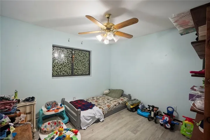 Bedroom featuring ceiling fan and light hardwood / wood-style flooring