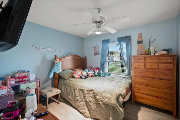 Bedroom with ceiling fan and light hardwood / wood-style floors