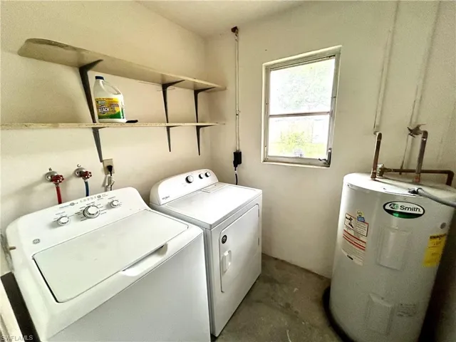 Washroom featuring washer and clothes dryer and electric water heater