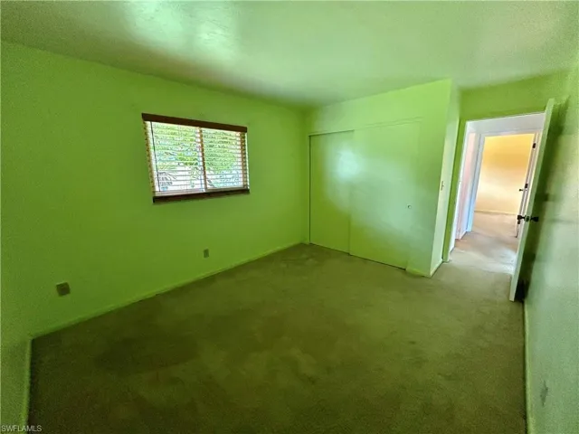 Unfurnished bedroom with carpet floors and a closet