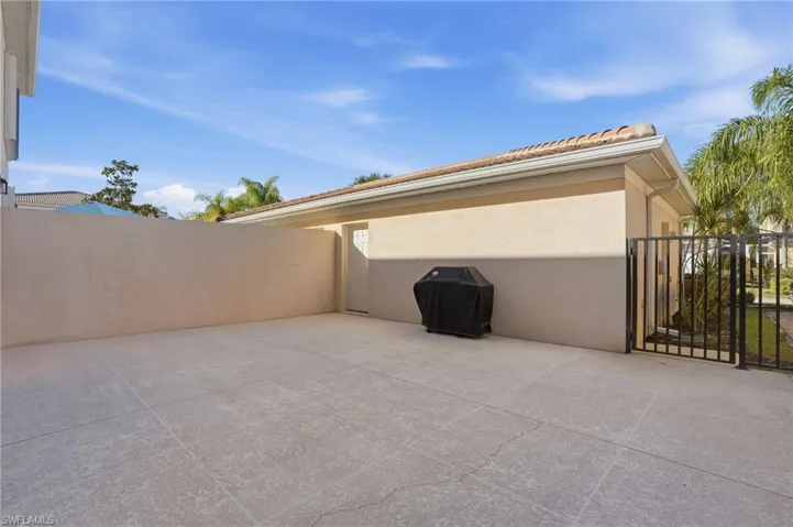 View of patio featuring a gate and grilling area
