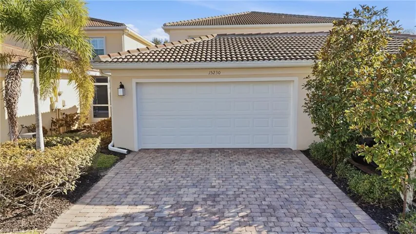 Garage featuring decorative driveway
