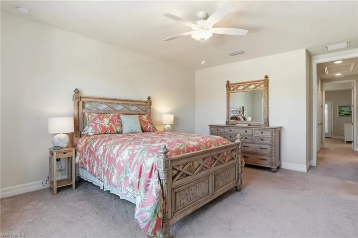 Bedroom featuring light carpet and a ceiling fan