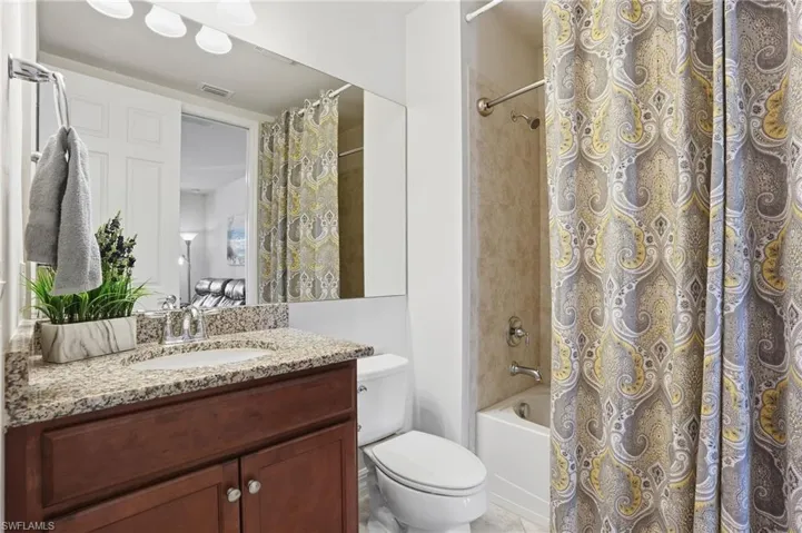 Full bathroom with vanity and shower / bath combo with shower curtain