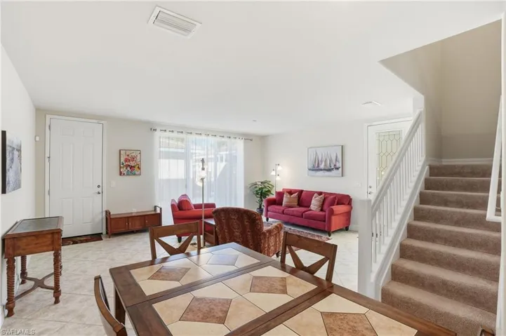 Dining room featuring stairway and light tile patterned flooring