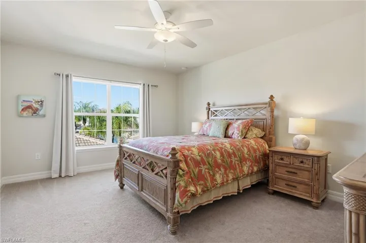 Bedroom with light carpet and ceiling fan