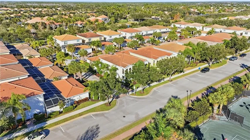 Aerial view of property and surrounding area with nearby suburban area