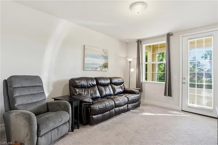 Living area featuring carpet and baseboards