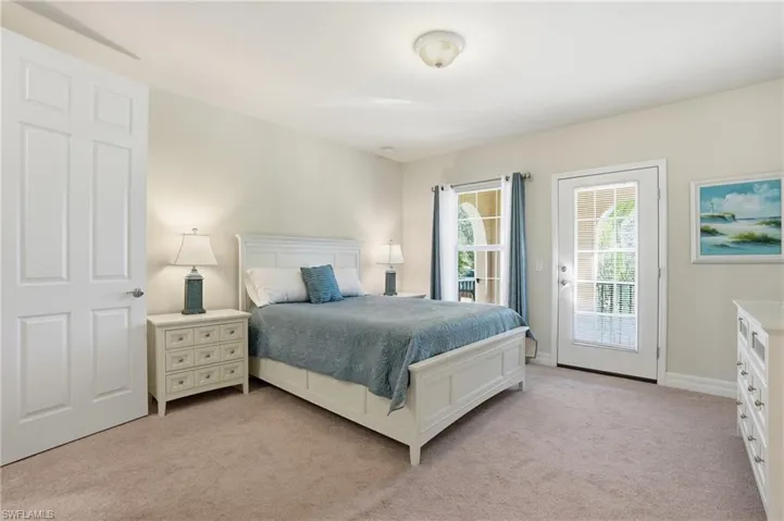 Bedroom with light colored carpet and access to outside