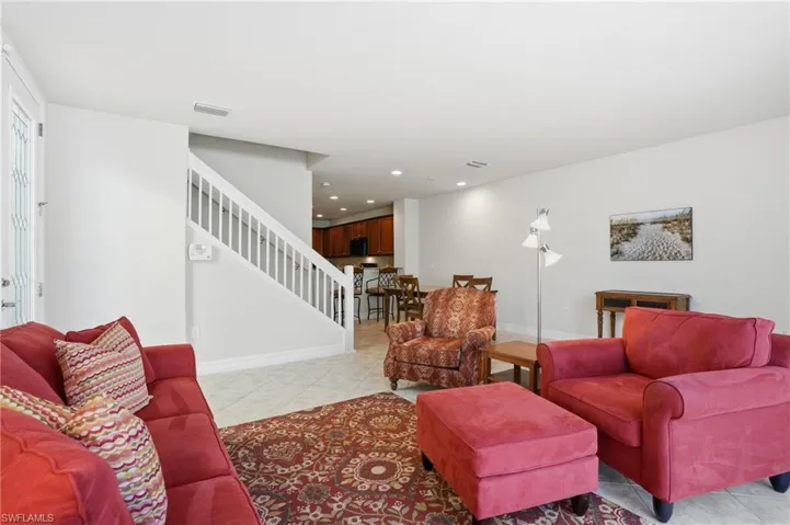 Living area with light tile patterned floors and recessed lighting
