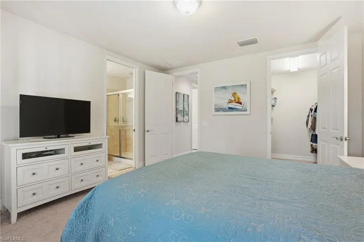 Bedroom featuring light colored carpet