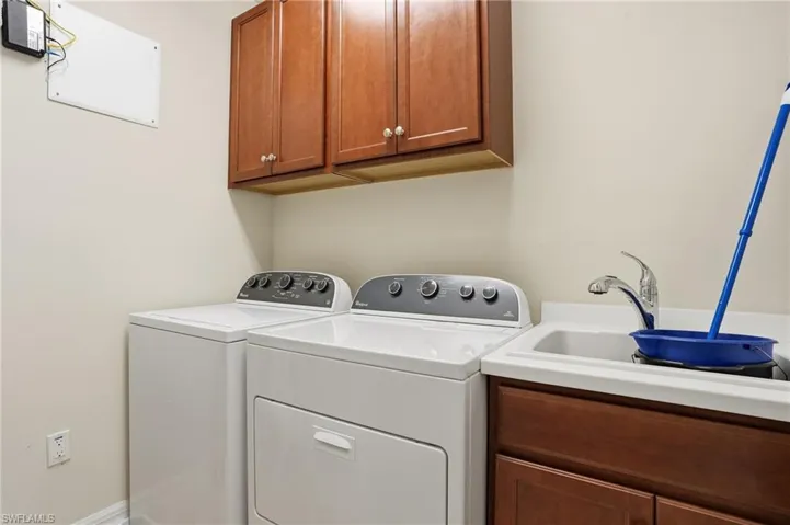 Laundry area featuring cabinet space and separate washer and dryer